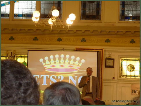 Lord Monckton speaking beside his slide show.